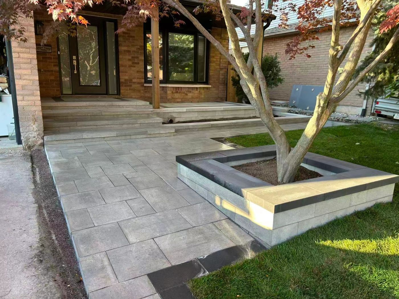 Finished front entrance with stone steps, interlock and fresh planting