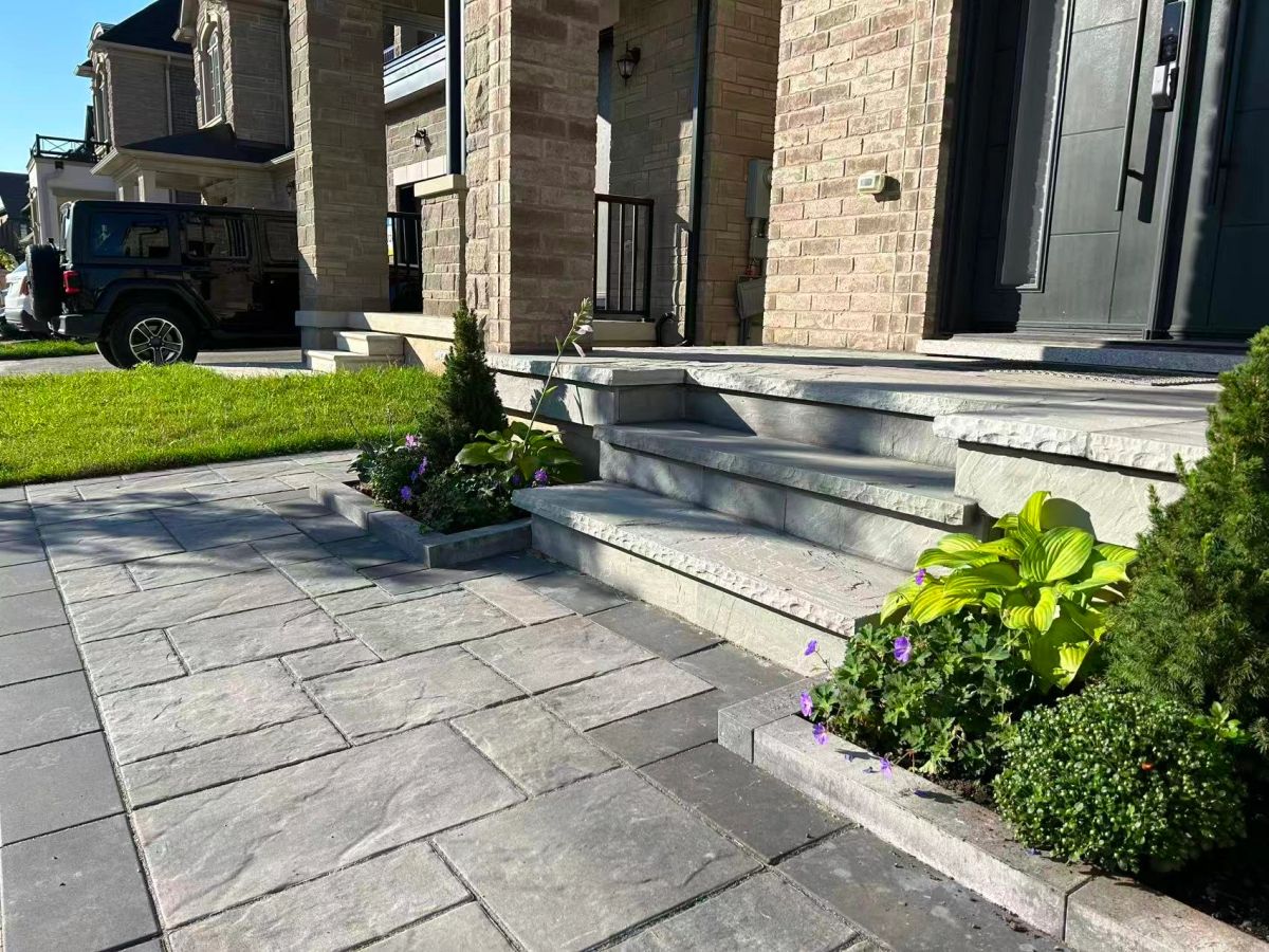 Front steps with stone planters and garden